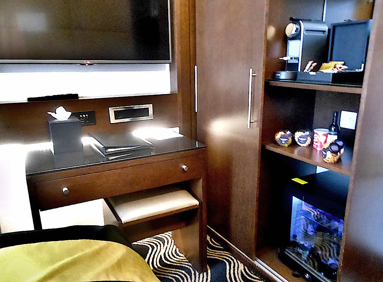 TV, desk and minibar inside the room