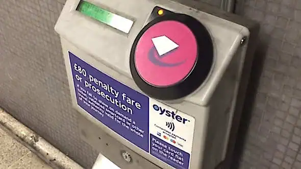 Pink Oyster reader at a train station
